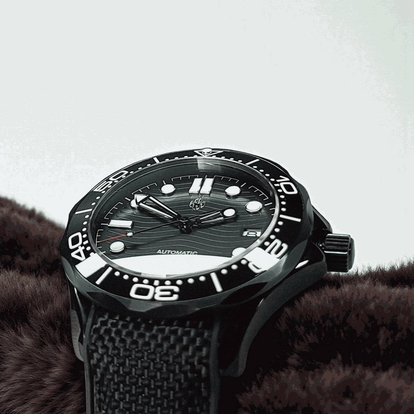 A Seiko Mod Omega Seamaster with a Black Dial laying on a brown sweater
