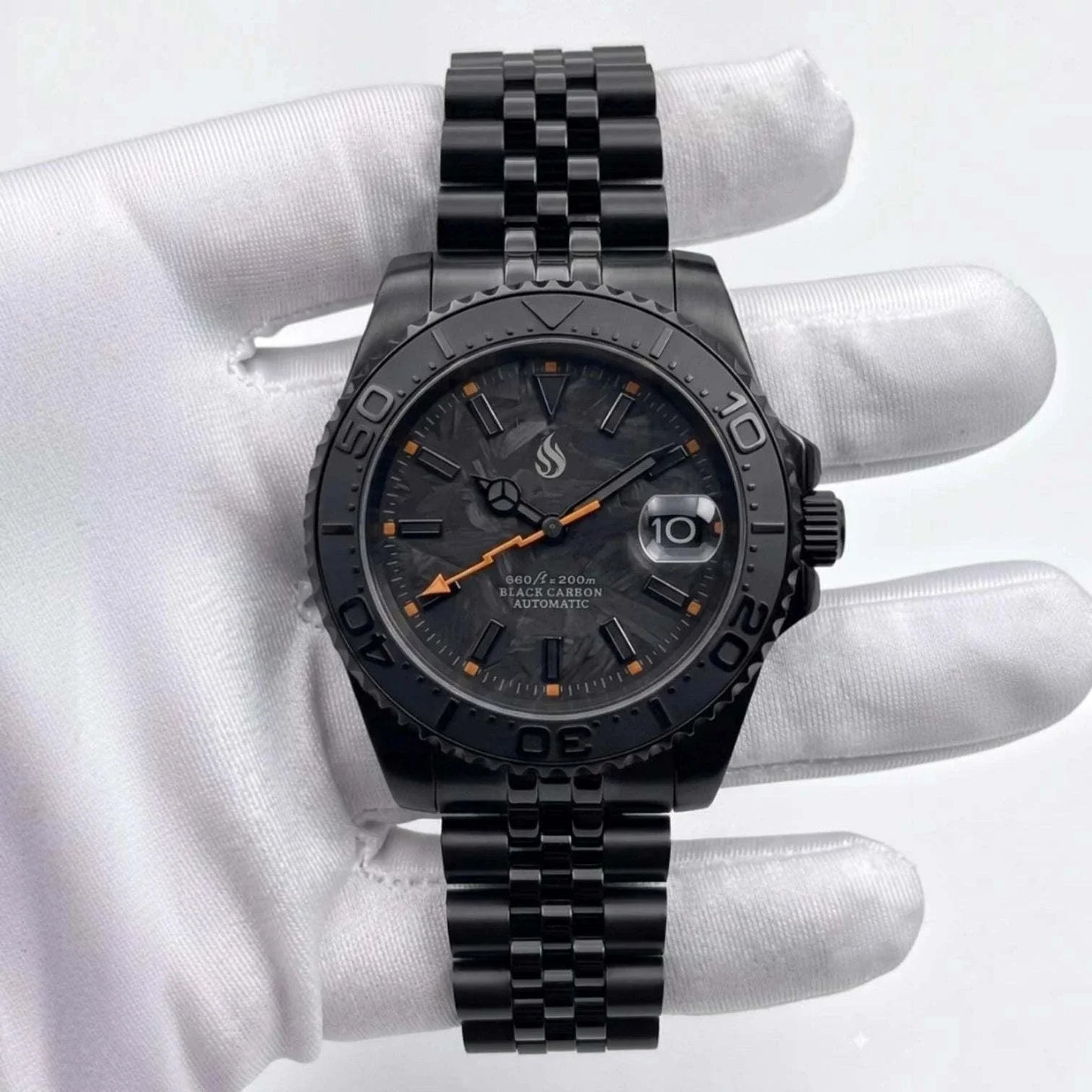 Seiko Mod Watches. A black stainless steel Yachtmaster wristwatch with a black dial, black bezel, and black link bracelet, featuring orange accents on the hands and markers, held by a white gloved hand.