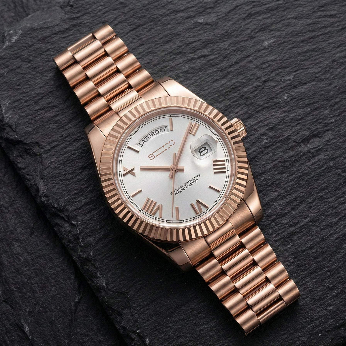 MODTIME rose gold automatic watch with white dial, Roman numerals, and day-date display on a stainless steel bracelet