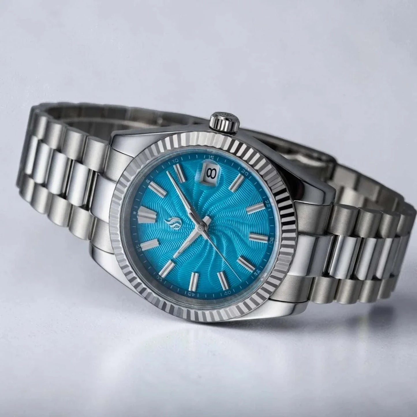 Seiko Mod Datejust stainless steel watch with a Tiffany Blue Guilloche dial, silver-tone fluted bezel, and matching steel link bracelet on a white background by Modtime Creations 