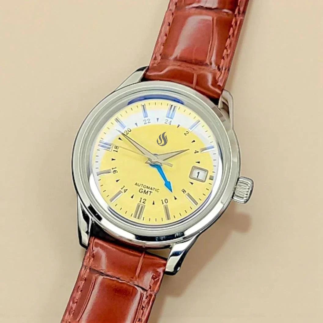 MODTIME custom GMT automatic pilot watch with a yellow dial, blue GMT hand, and brown leather strap.