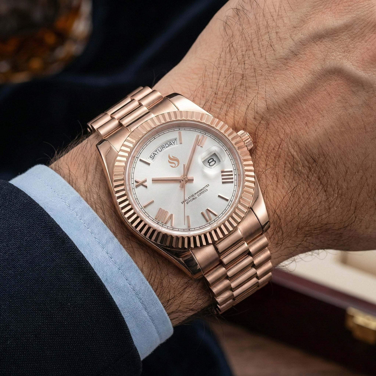 MODTIME rose gold automatic watch with white dial, Roman numerals, and day-date display on a stainless steel bracelet