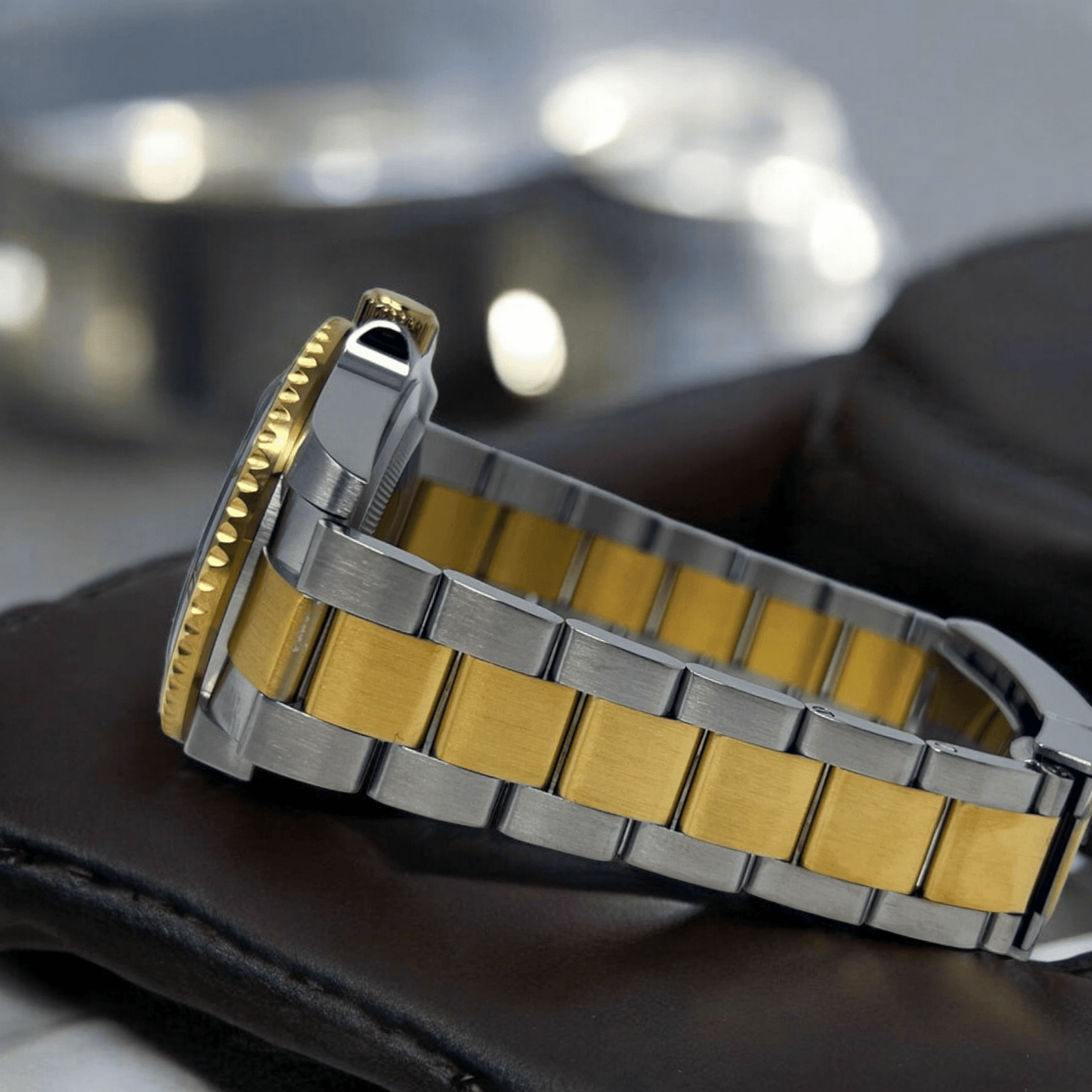 MODTIME SeikMariner two-tone diver watch with gold and stainless steel bracelet and ceramic bezel, side view.