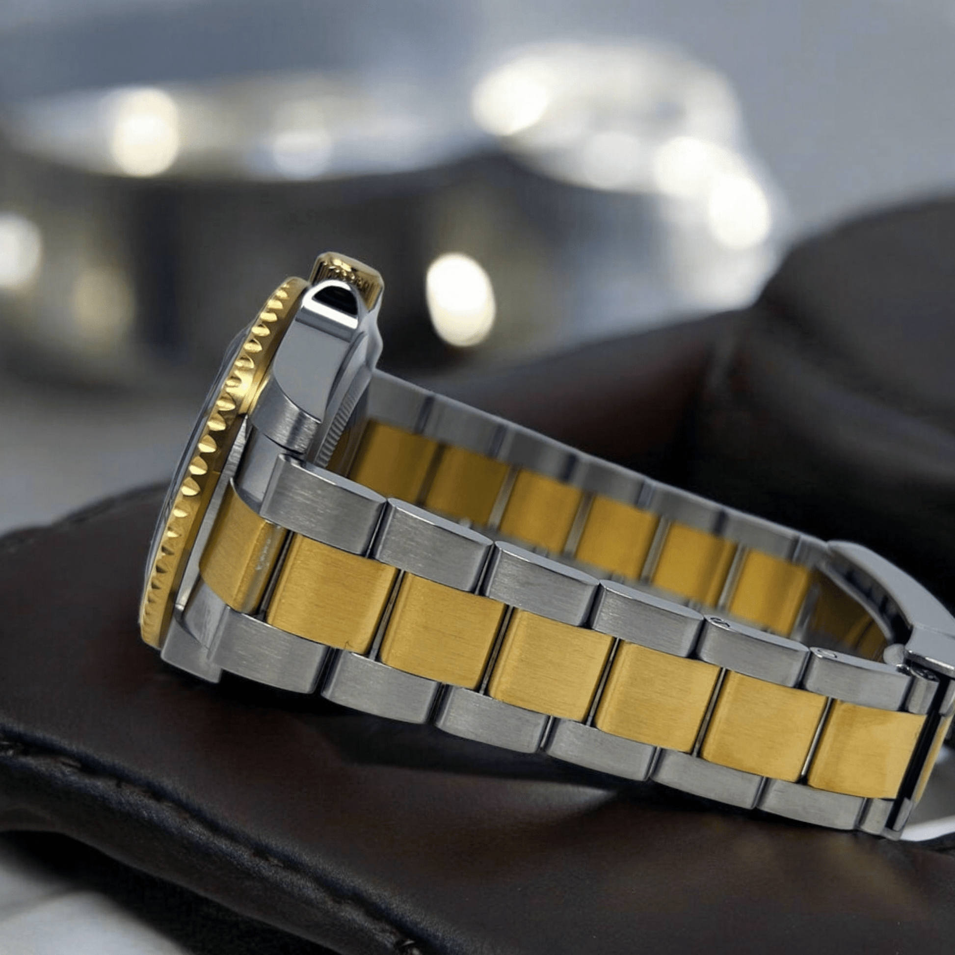 MODTIME SeikMariner two-tone diver watch with gold and stainless steel bracelet and ceramic bezel, side view.