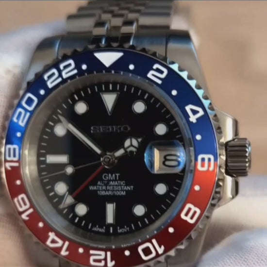 A Close up Viseo of a Blue Red Pepsi bezel GMT Seiko Mod 