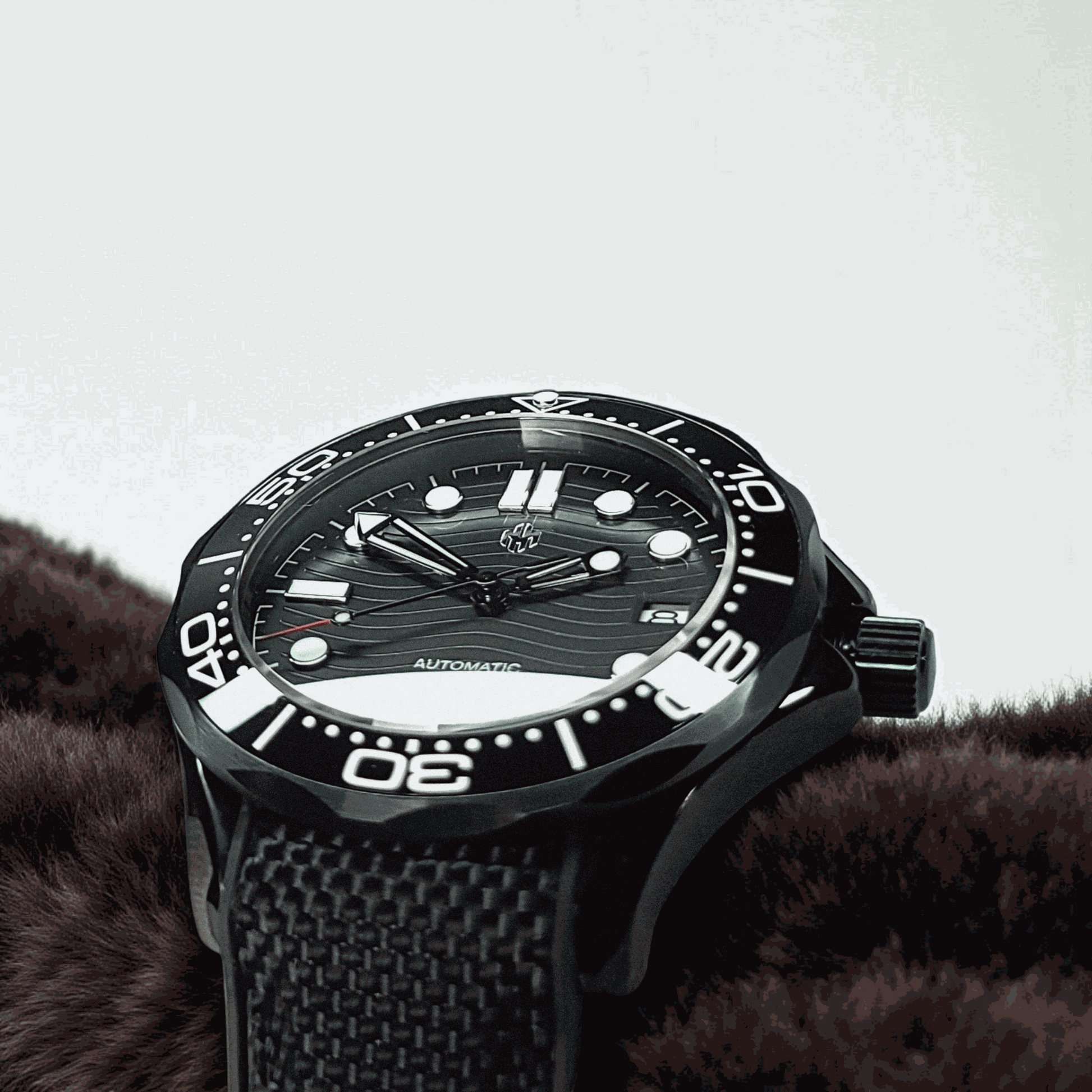 A Seiko Mod Omega Seamaster with a Black Dial laying on a brown sweater 