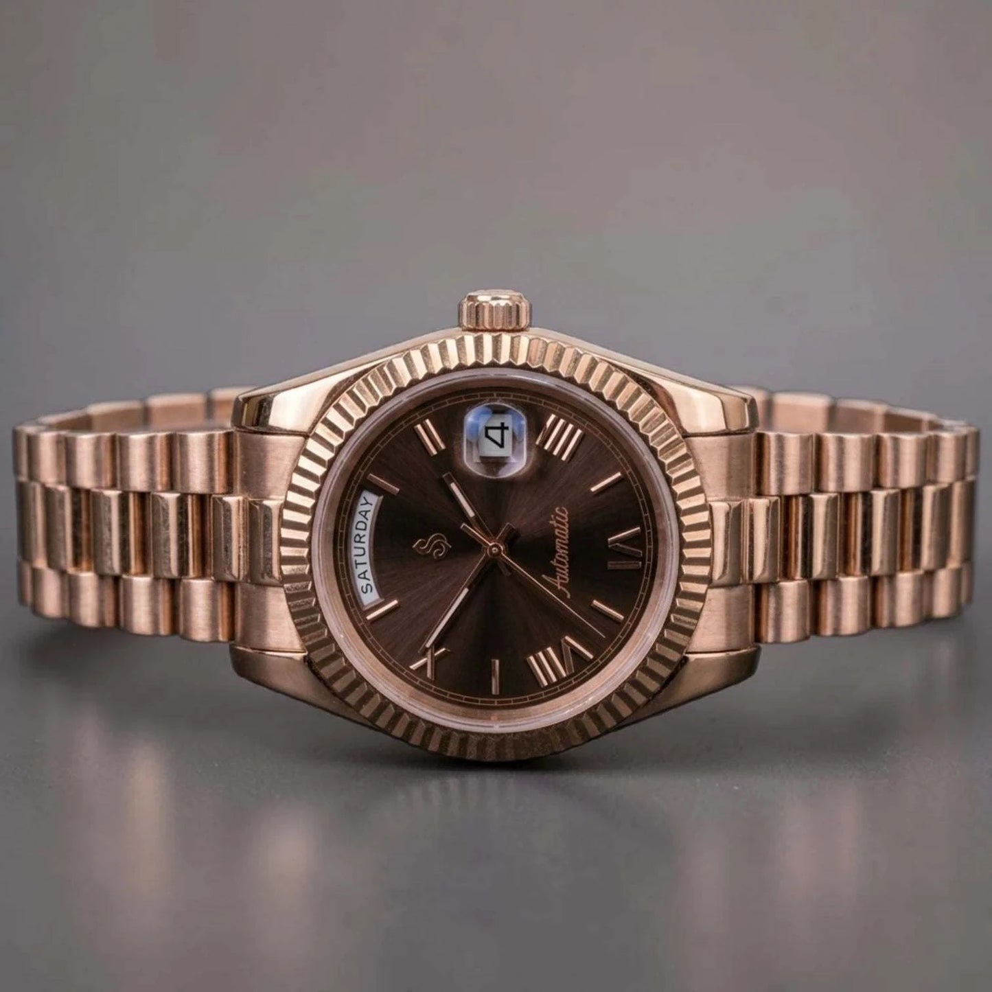 Modded Seiko luxury watch with rose gold case and chocolate dial displaying day and date features