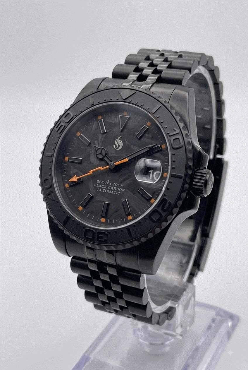 Seiko Mod watches. A black carbon automatic Yachtmaster watch with a black bezel, black link bracelet, and orange accents on the dial, displayed on a clear stand against a light gray background.
